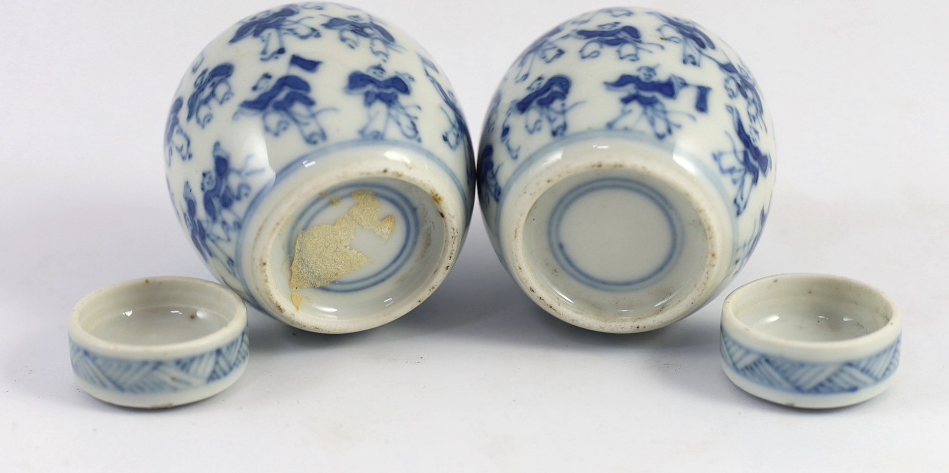 A pair of 19th century Chinese blue and white boys miniature jars and covers, 5.5 cm high